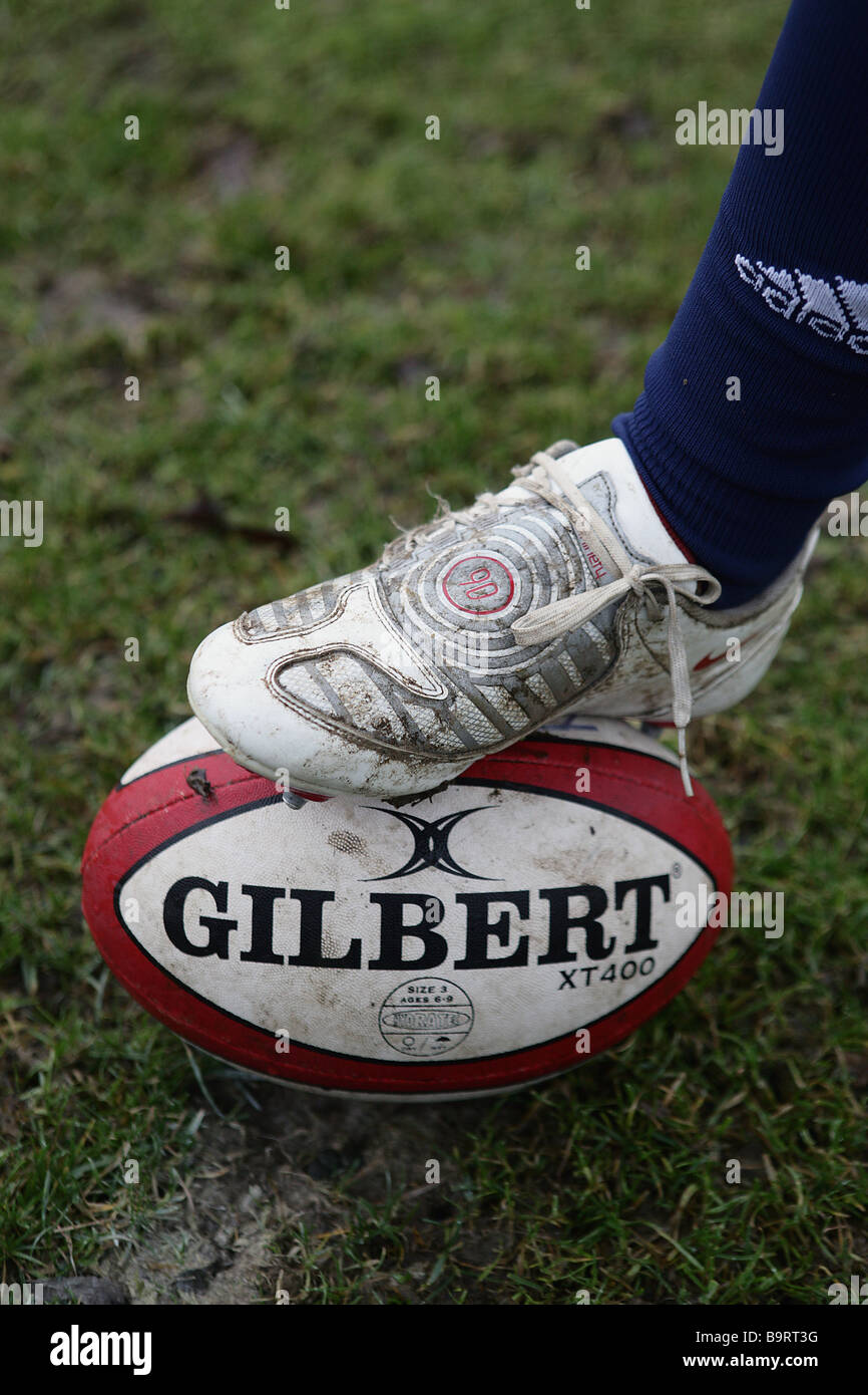 Boy with foot on rugby ball Stock Photo Alamy