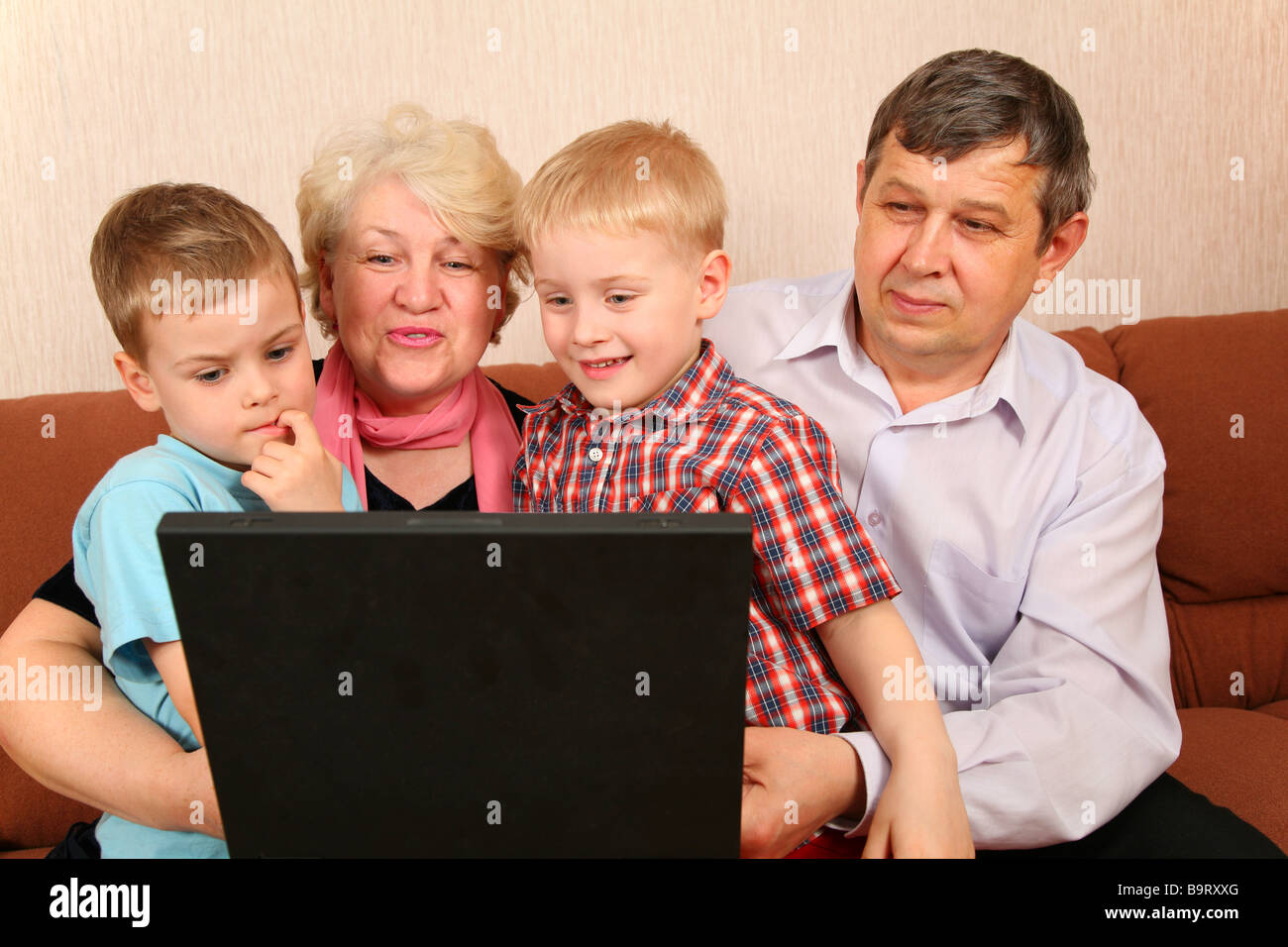 grandparents with grandchildren with notebook Stock Photo Alamy