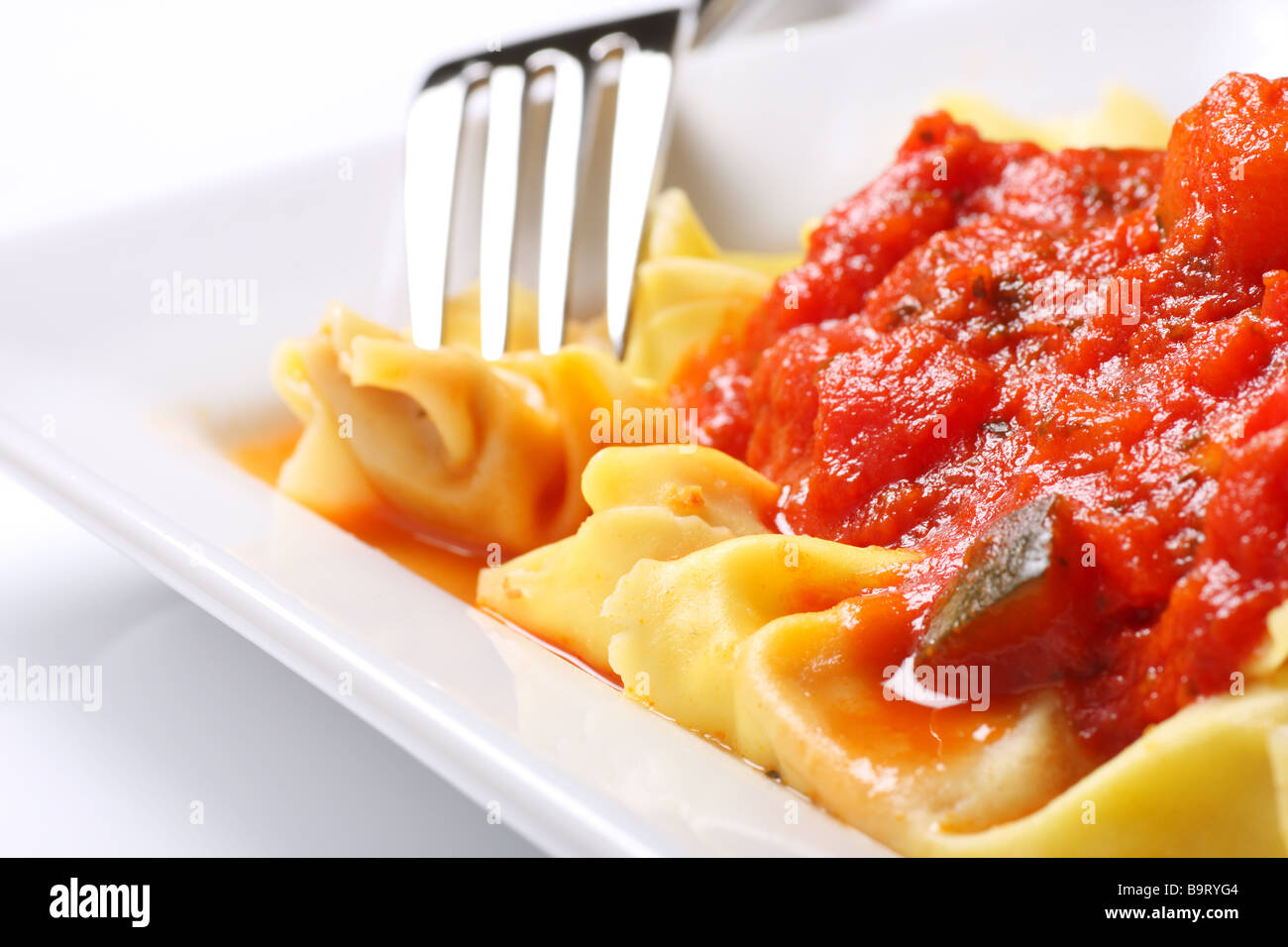 prepared tortellini with chunky vegetable tomato sauce Stock Photo