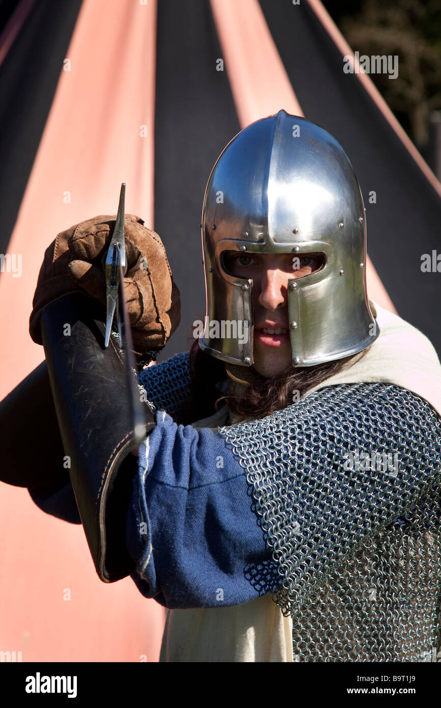 Helmeted medieval 13th - 16th century swordsman; Armed Costumed Performers, soldiers at Hawick Reivers Festival, Scottish Borders,  Scotland, UK Stock Photo