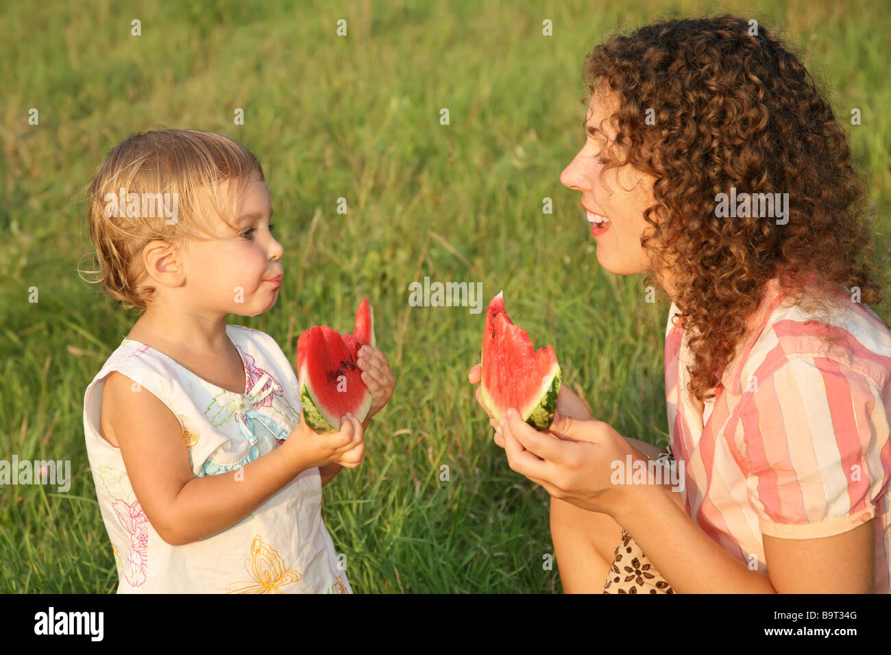 mother and daughter eat watermelon Stock Photo
