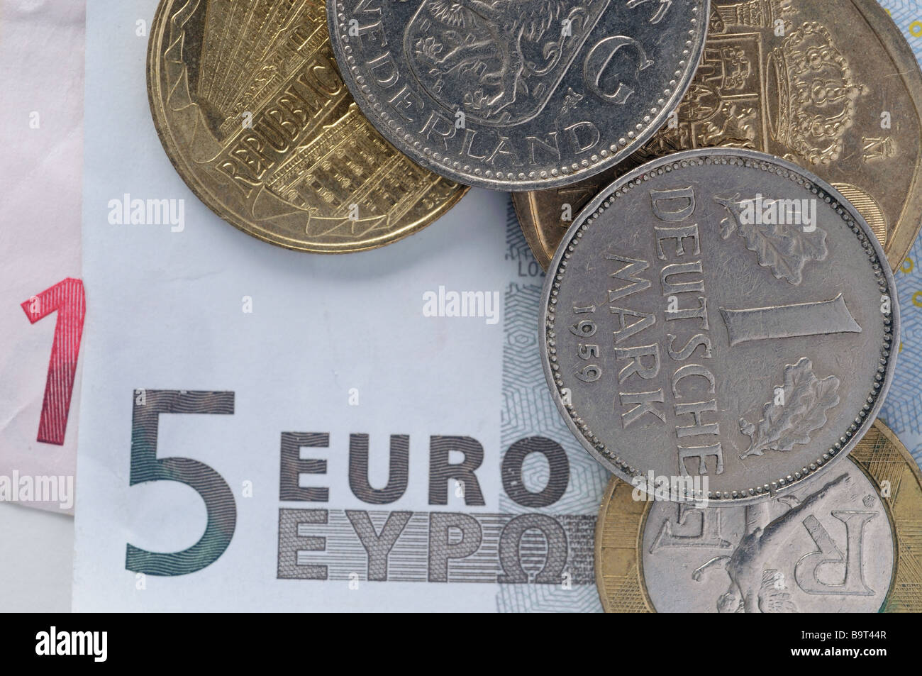 A euro banknote with old european coins Stock Photo