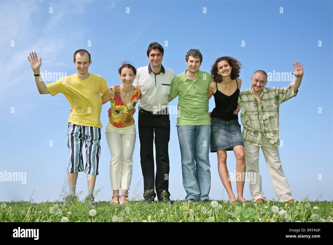 Wave Hello In Group The group waves hands Stock Photo - Alamy