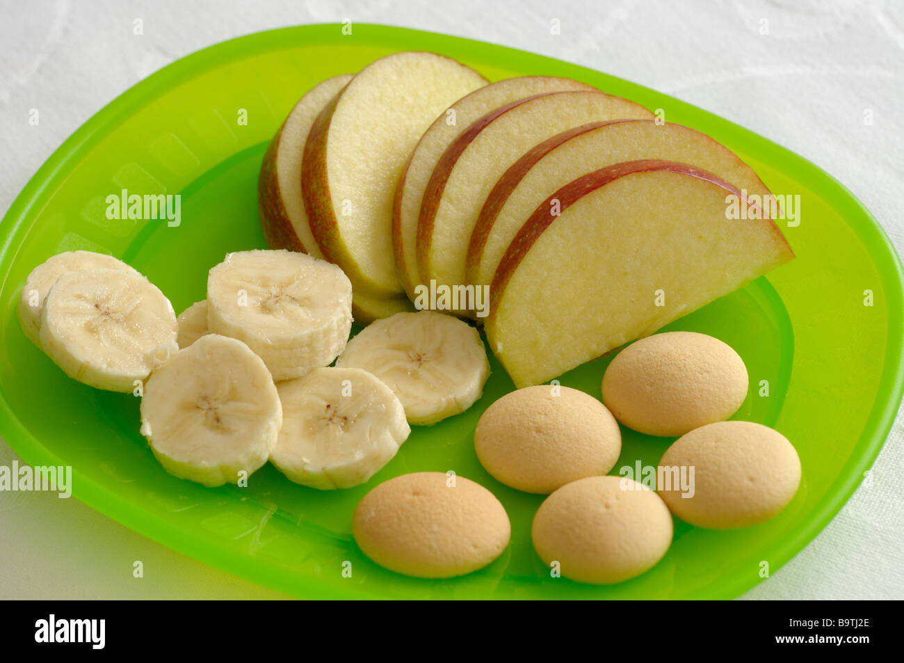 children-s-healthy-meal-consisting-of-apples-bananas-and-biscuits-stock