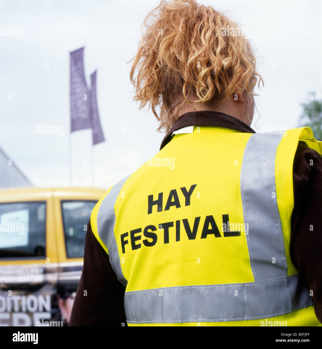 Hay Festival sign on a yellow fluorescent stewards jacket Hay on Wye, Wales, UK Stock Photo