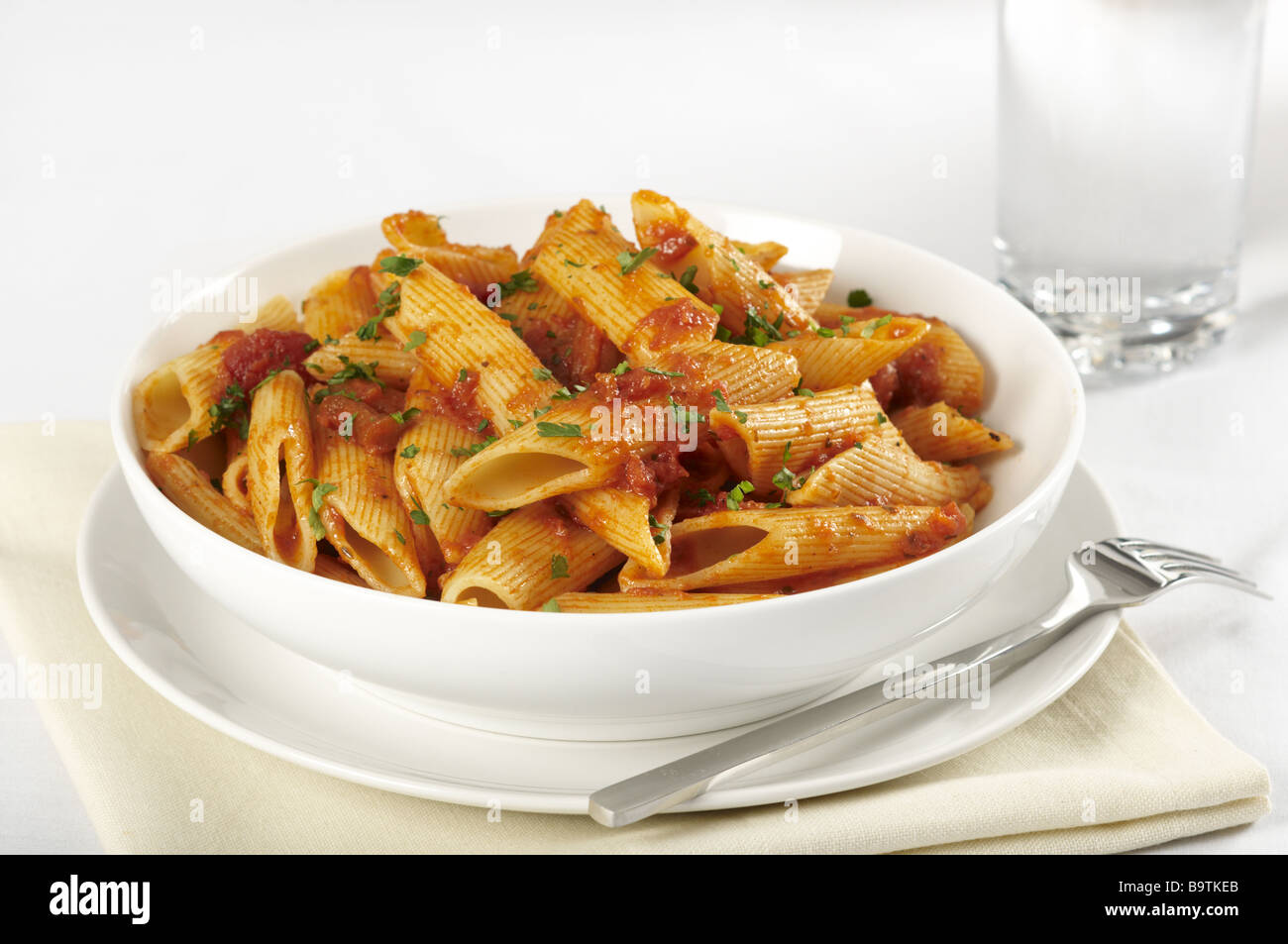 Bowl of penne pasta in a tomato sauce Stock Photo