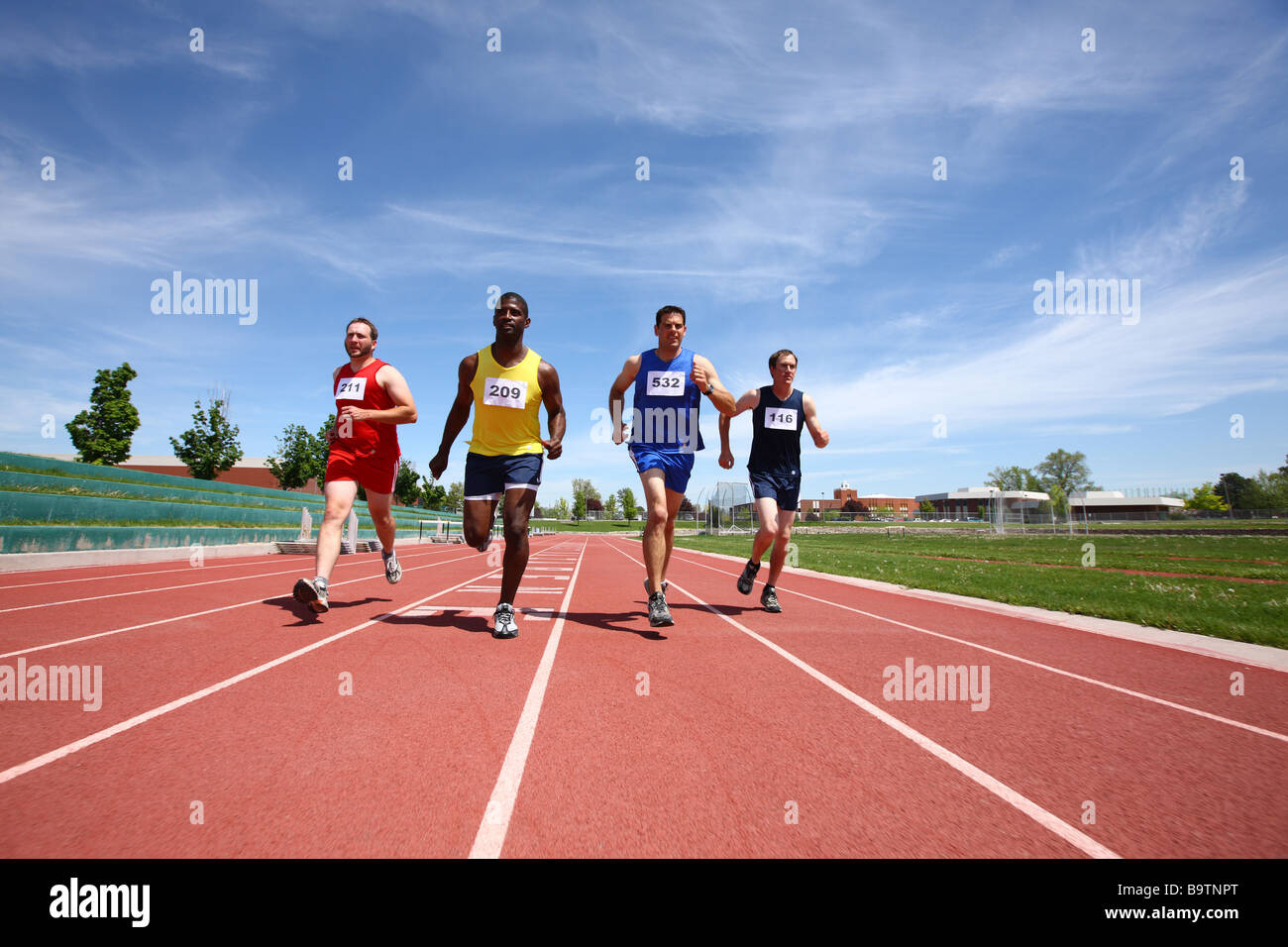 Track runners in race Stock Photo Alamy