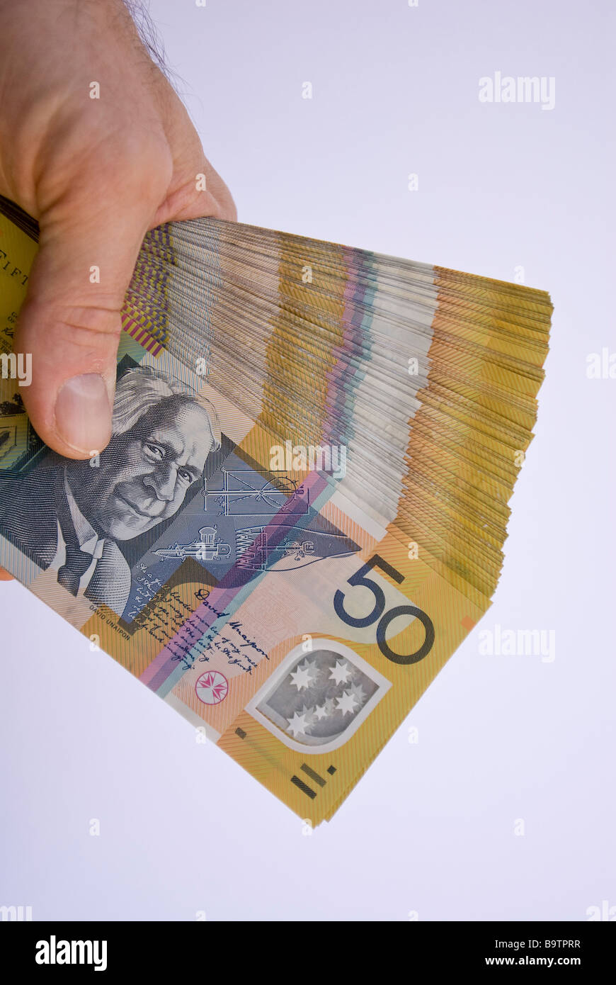 A fan of A$20,000 Aus $20,000 thousand Australian dollars in a hand Stock Photo - Alamy