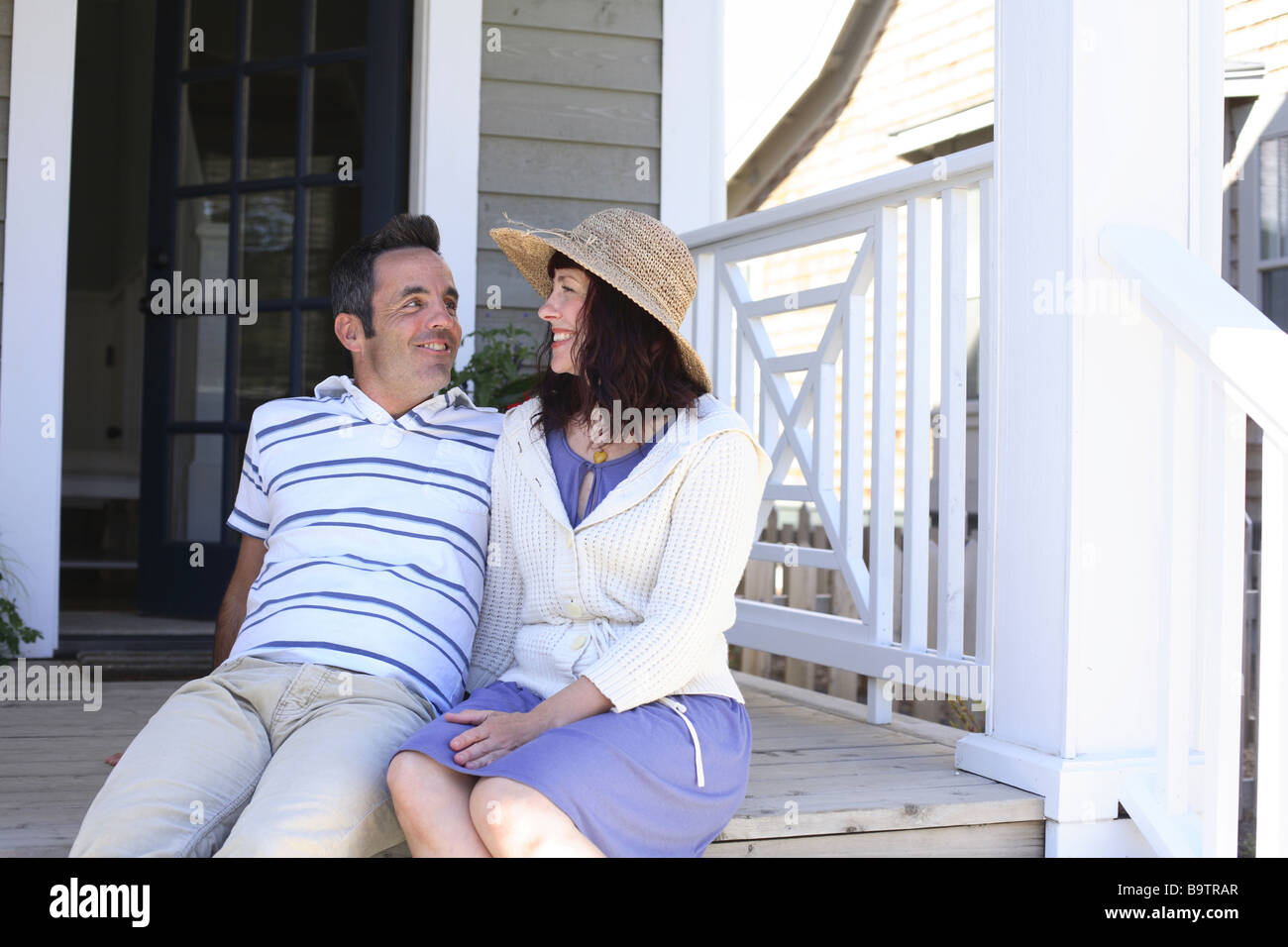 Couple sitting on porch together Stock Photo - Alamy