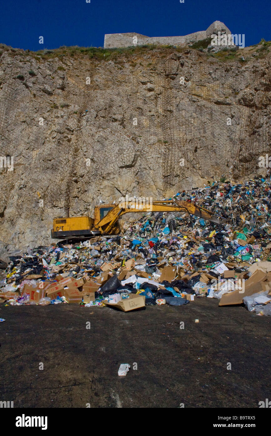 Digger moving rubbish at the rubbish tip. Gibraltar. Stock Photo