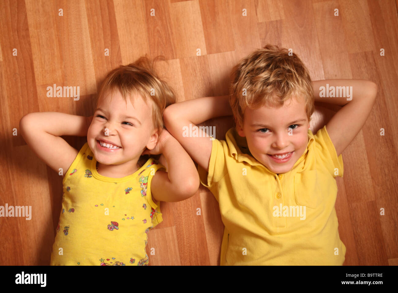 two children lie on the floor 3 Stock Photo Alamy