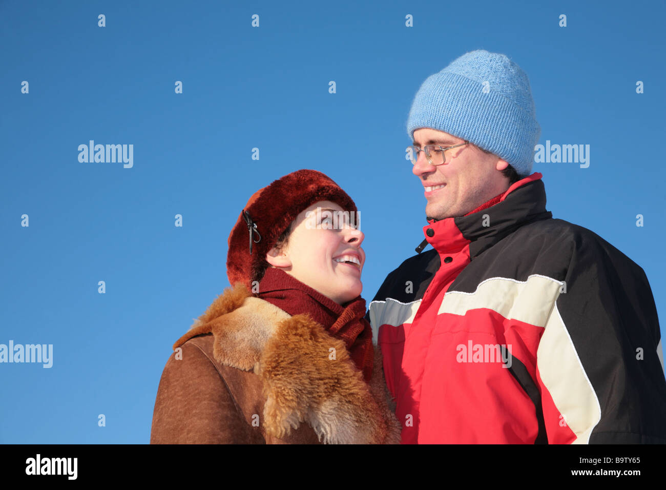 couple against blue sky background in winter 3 Stock Photo - Alamy
