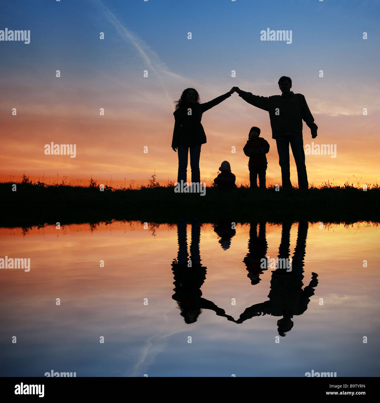 silhouette family house on sunset water Stock Photo - Alamy