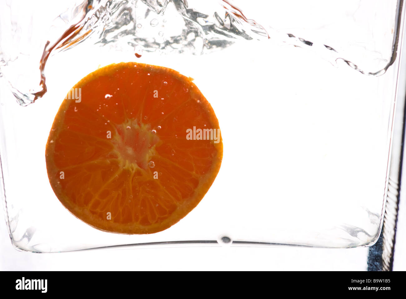 Orange slice in water against a white background Stock Photo Alamy
