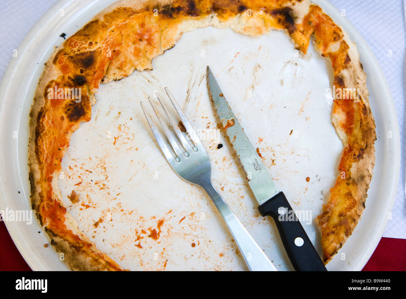 Pizza with middle eaten but round crust outside remains Stock Photo