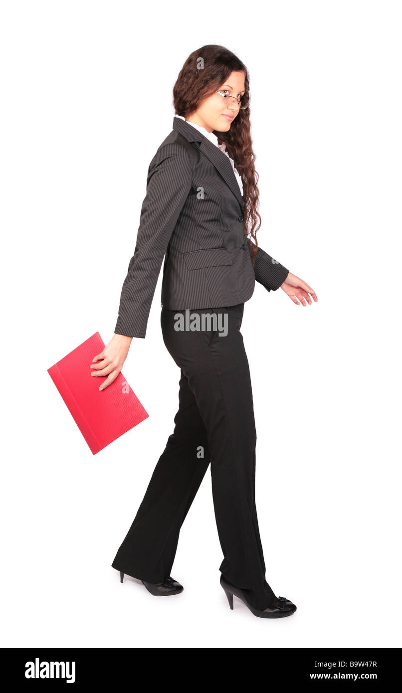 beautiful brown-haired woman goes with red folder Stock Photo