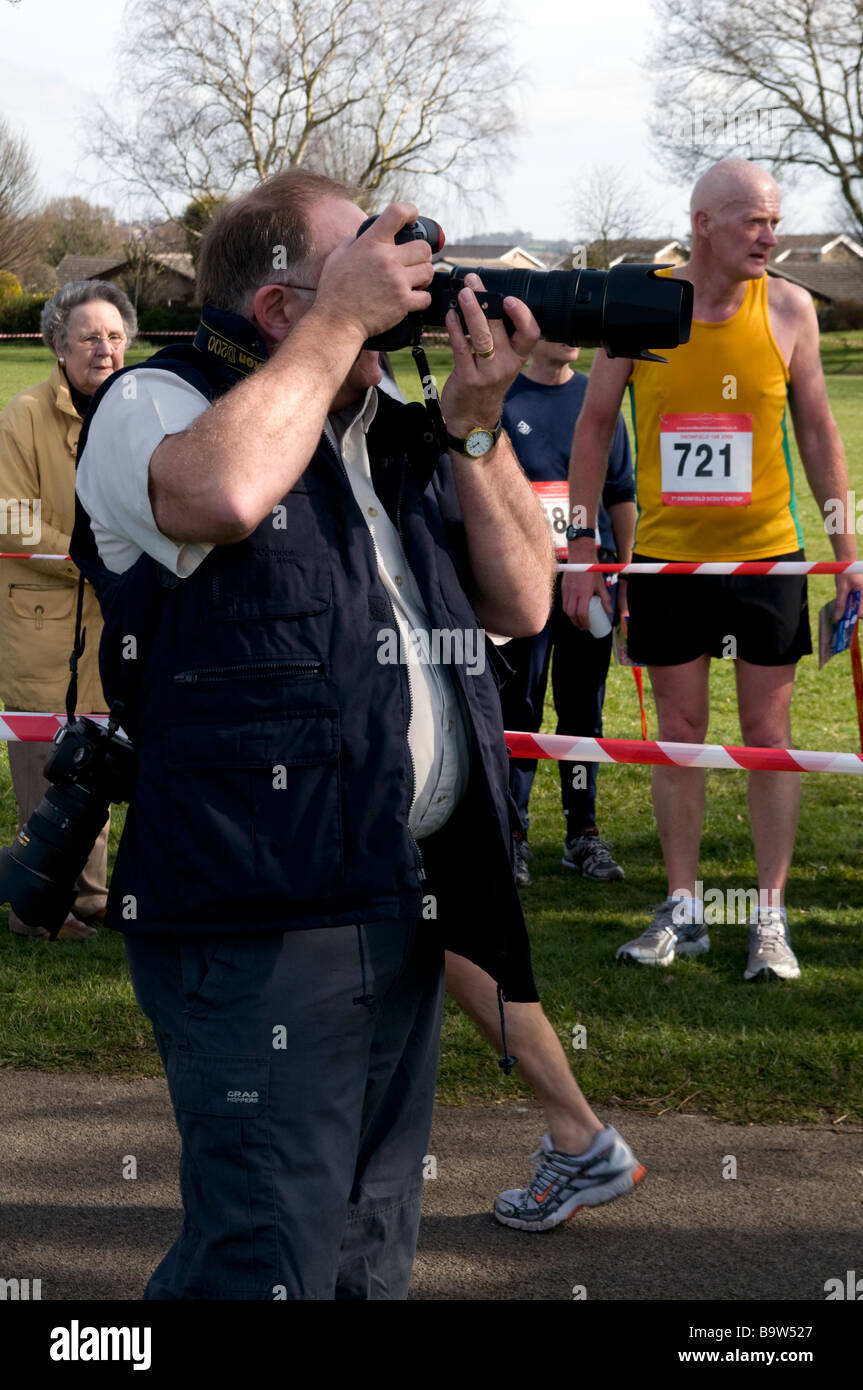 Photographer at finish line of the Dronfield 10K Marathon Derbyshire England Stock Photo