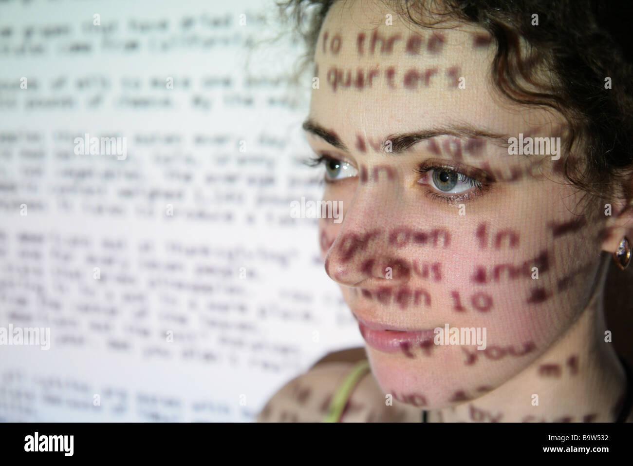 text is projected on face of woman Stock Photo