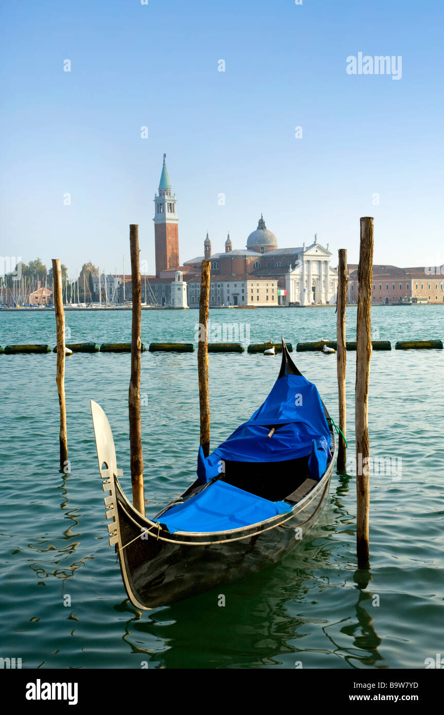 A row of blue gondolas docked at shore in Venice Italy Stock Photo - Alamy