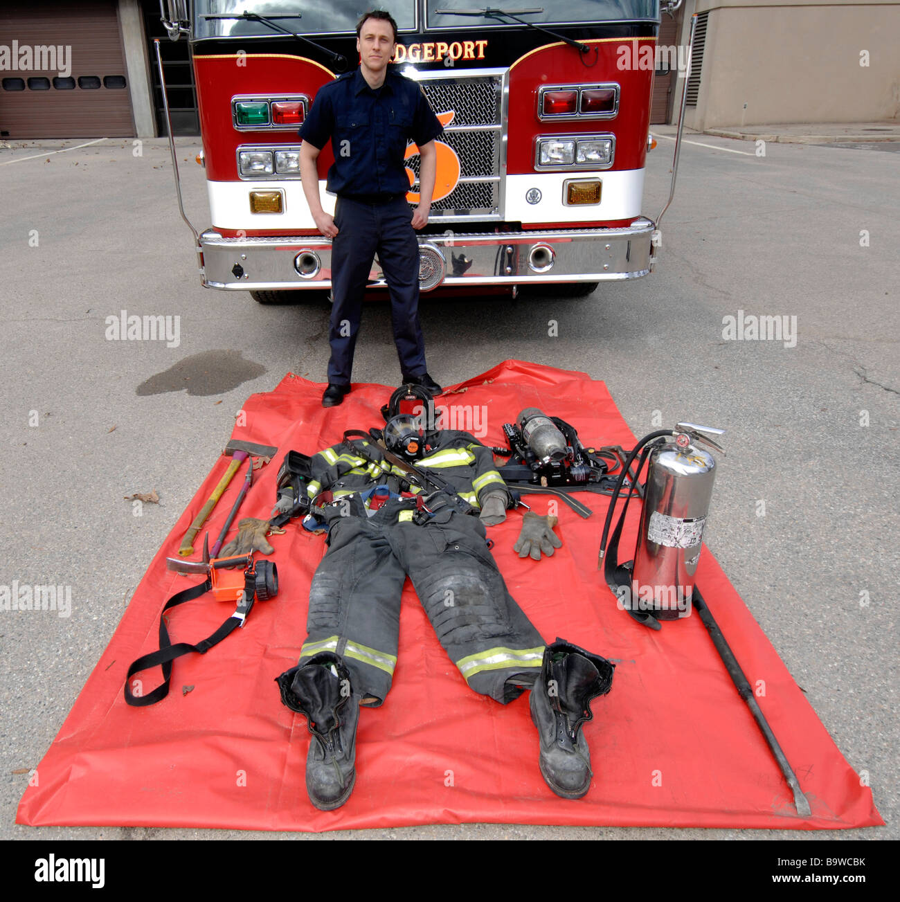 Firefighter with gear he takes on calls laid out in front of him Stock Photo