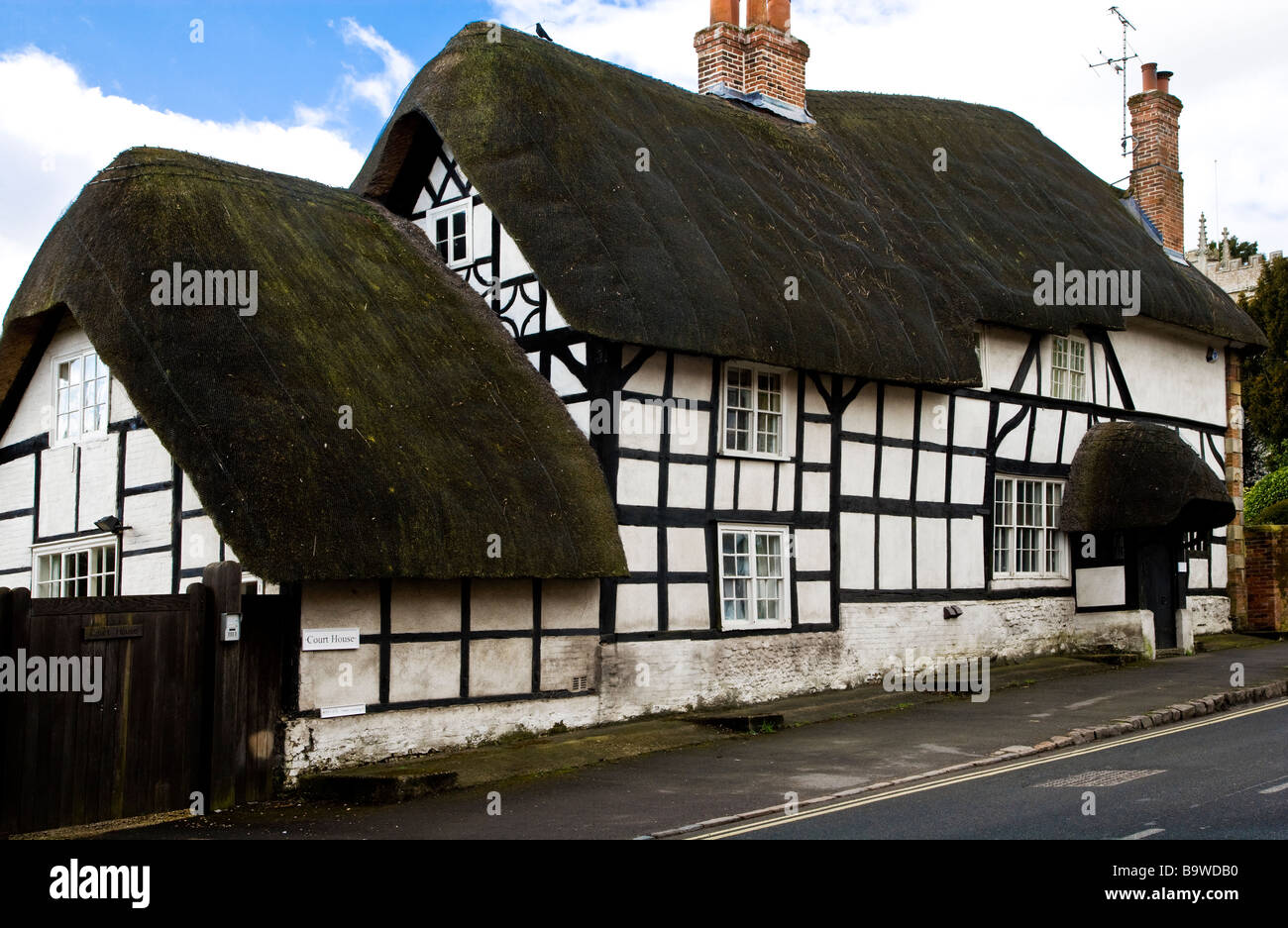 An old thatched timber framed Tudor cottage in the English village of
