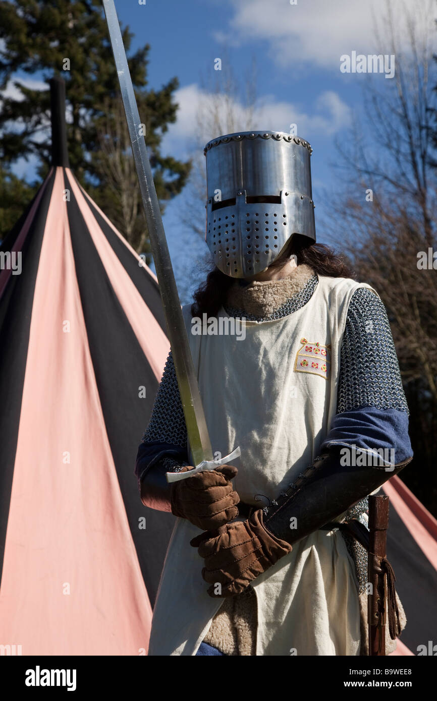 Helmeted  medieval 13th - 16th century swordsman; Armed Costumed Performers, soldiers, at Hawick Reivers Festival, Scottish Borders,  Scotland, UK Stock Photo