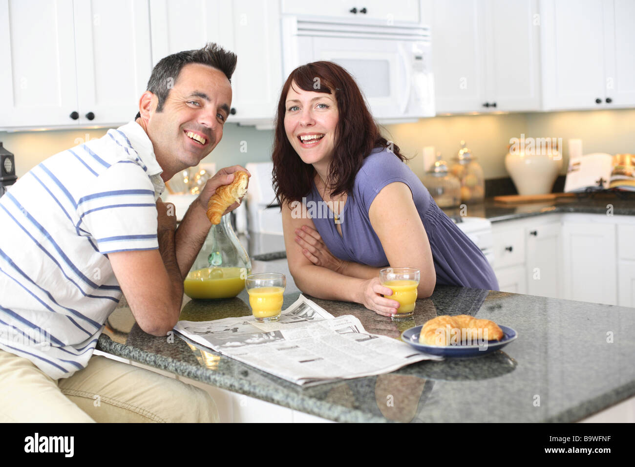 Couple having breakfast in kitchen Stock Photo