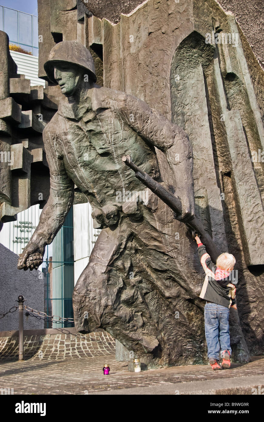 Boy pulling the trigger of an statue´s gun, Warsaw, Poland, Europe. Stock Photo