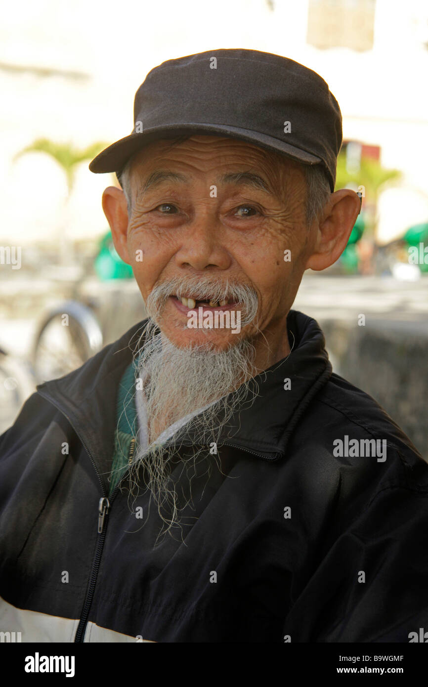 bearded old man with hat in Hoi An Vietnam Stock Photo
