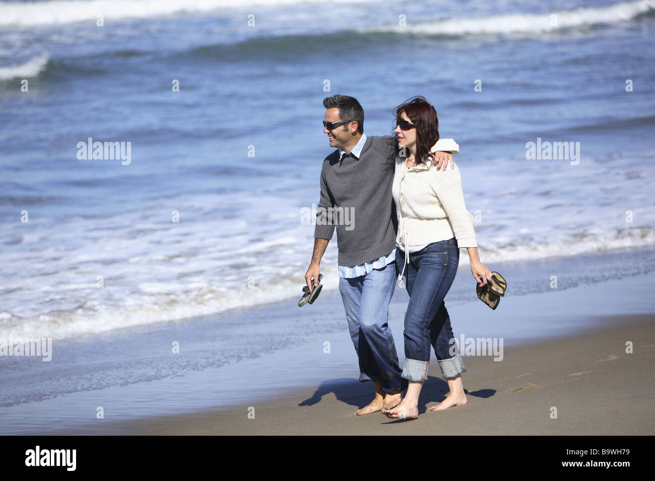 Couple walking on beach Stock Photo