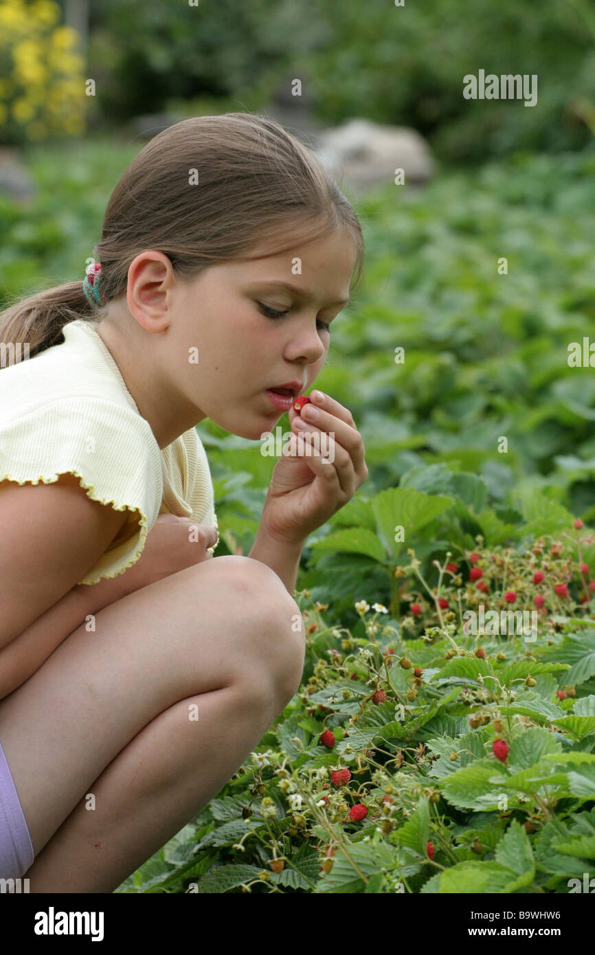 Girl eating strawberries Stock Photo