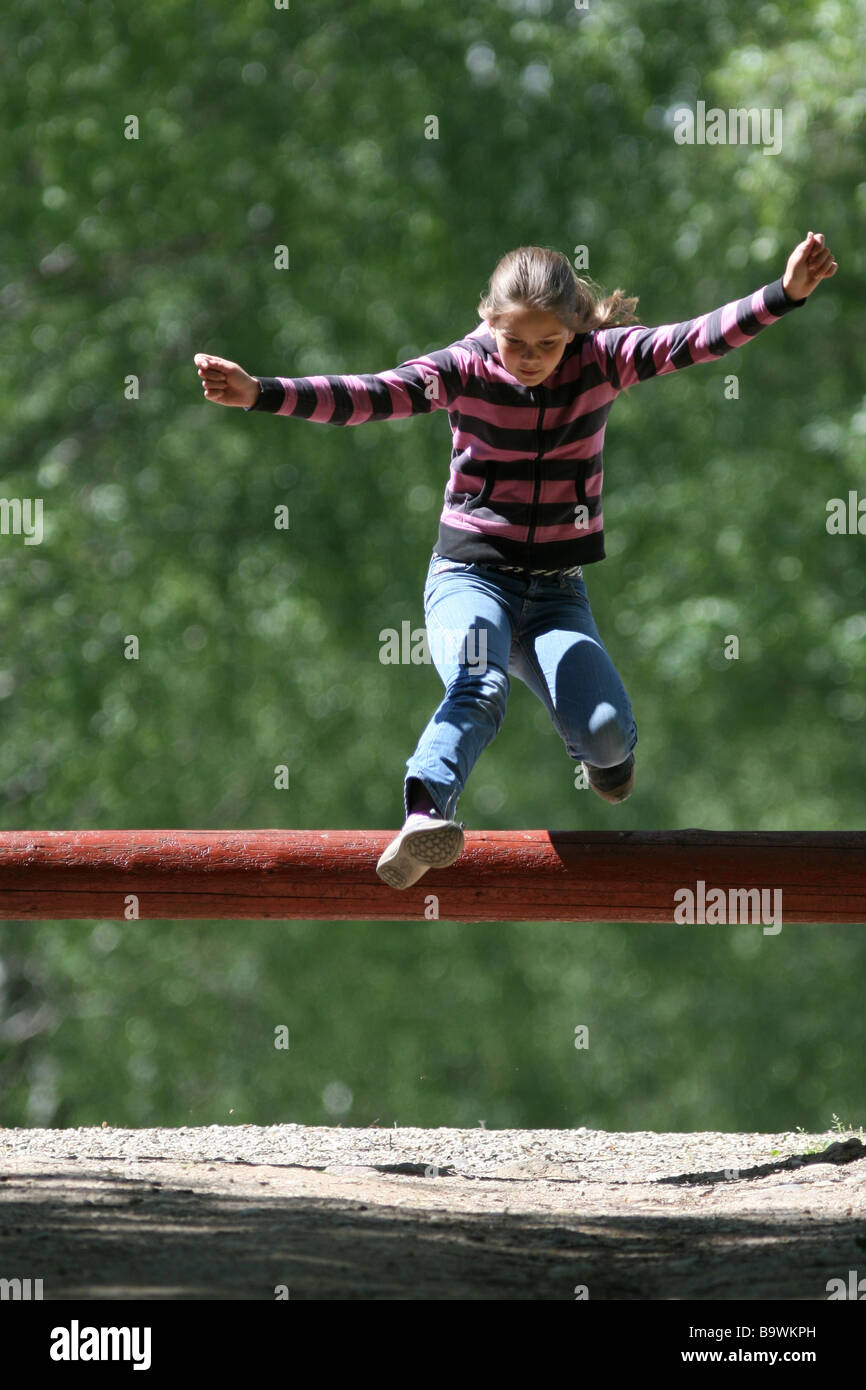 Girl jumping the hurdle Stock Photo