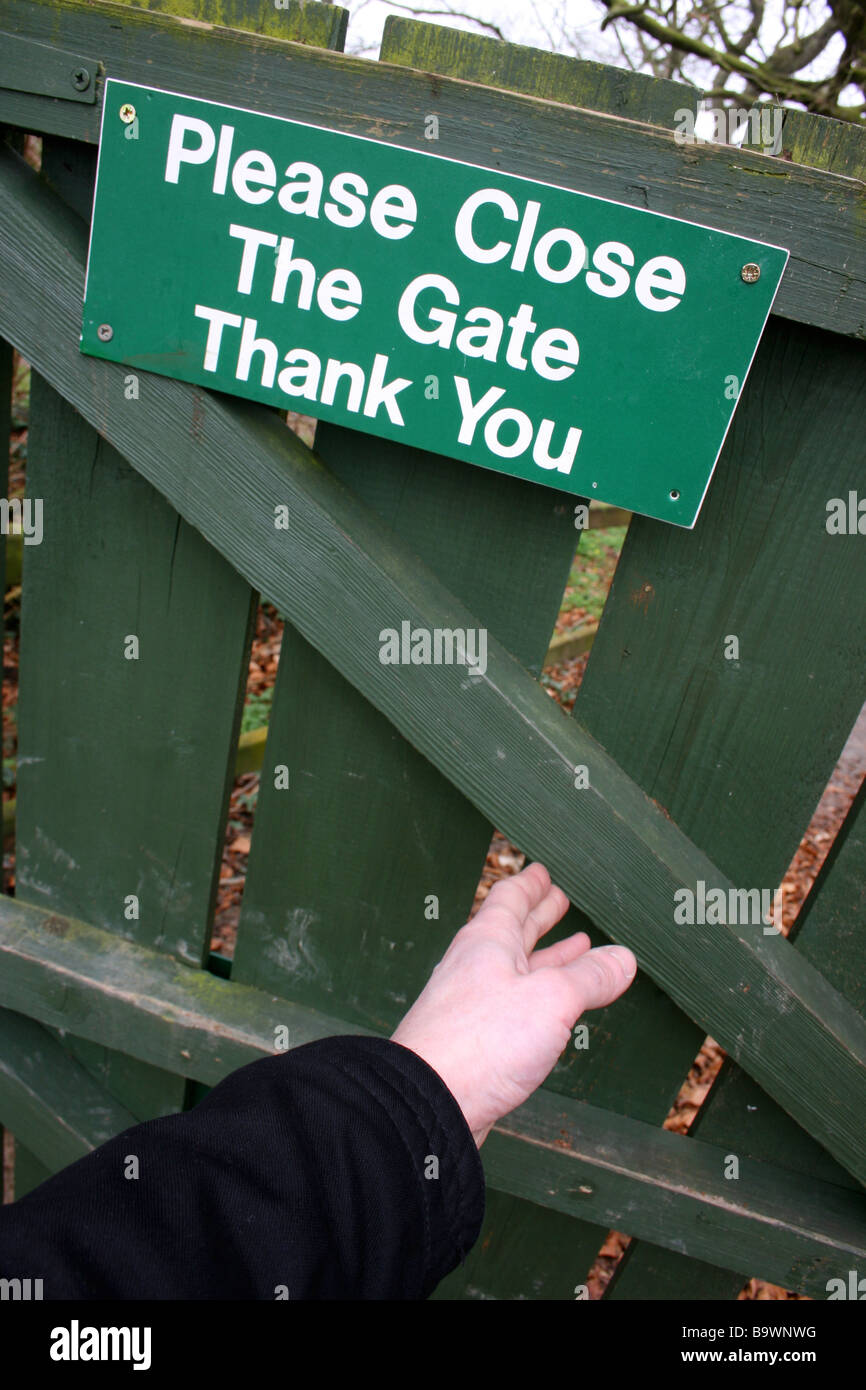 Man closing a wooden gate Stock Photo Alamy