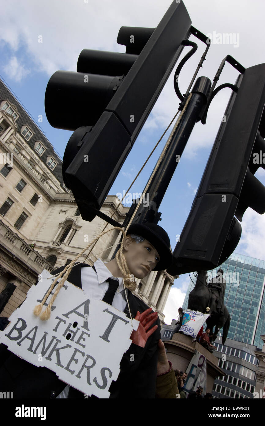 G20 demonstration London mock hanging of a banker from traffic light with eat the bankers sign Stock Photo