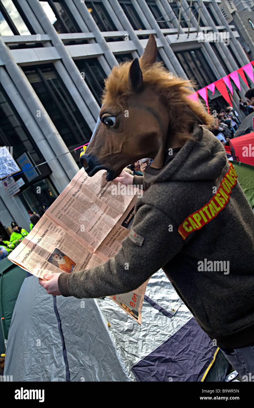 Climate protester dressed in horse costume reading FT Stock Photo