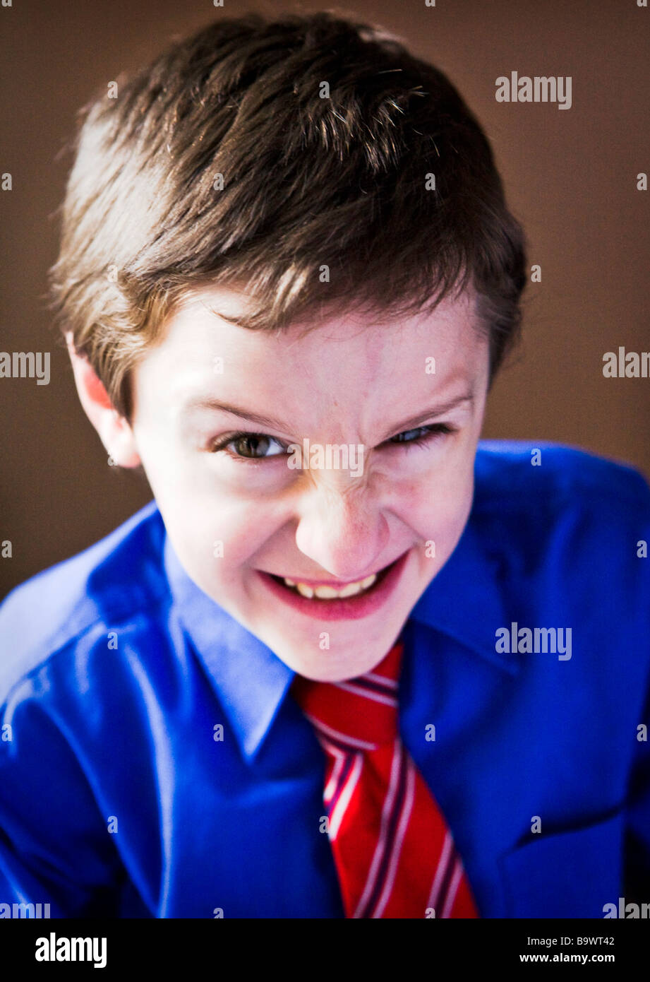 young boy in shirt and tie with aggressive look on his face Stock Photo