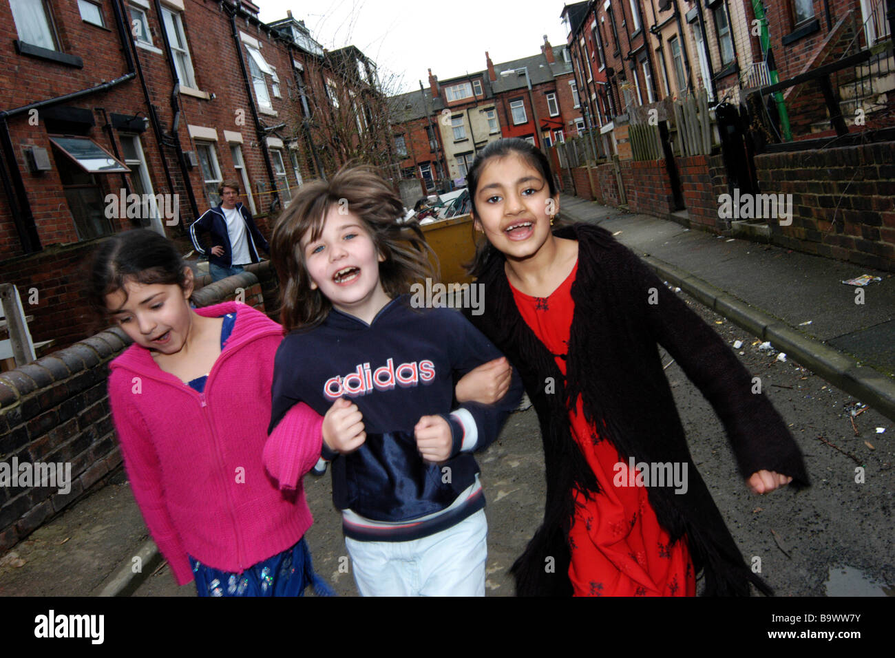 Girls play out on the street Beeston Leeds Stock Photo