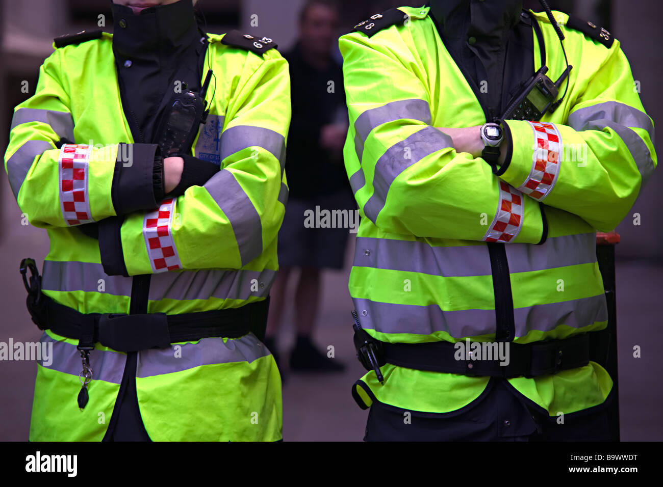 Two police constables with folded arms, torsos only Stock Photo