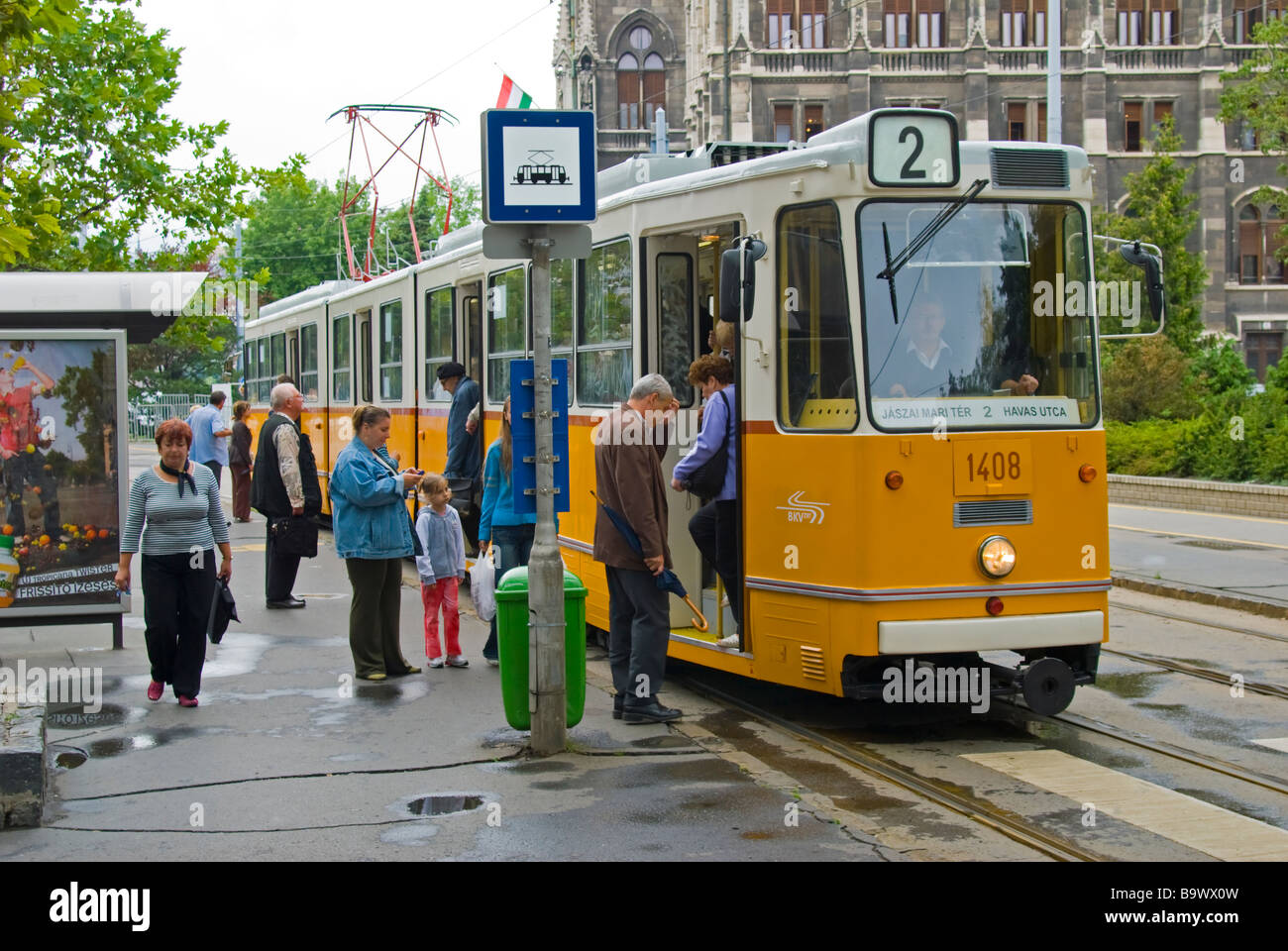 Budapest, Hungary. Tram and people at tram stop. Rainy day Stock Photo