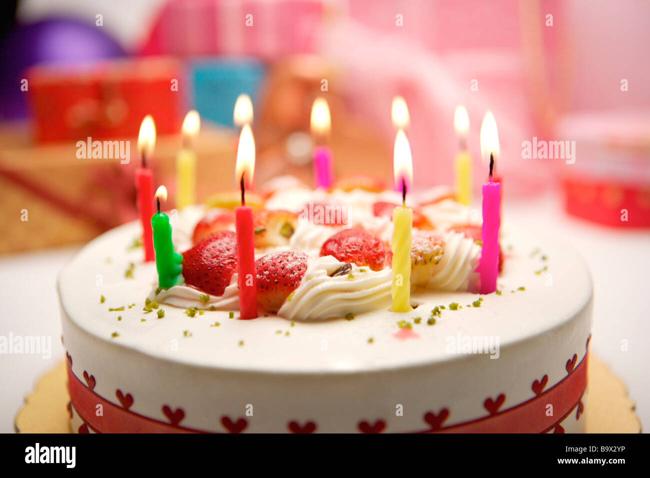 Birthday cake with burning candles Stock Photo - Alamy