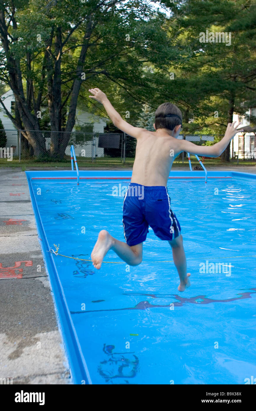 9 year old boy jumping into the swimming pool Stock Photo Alamy