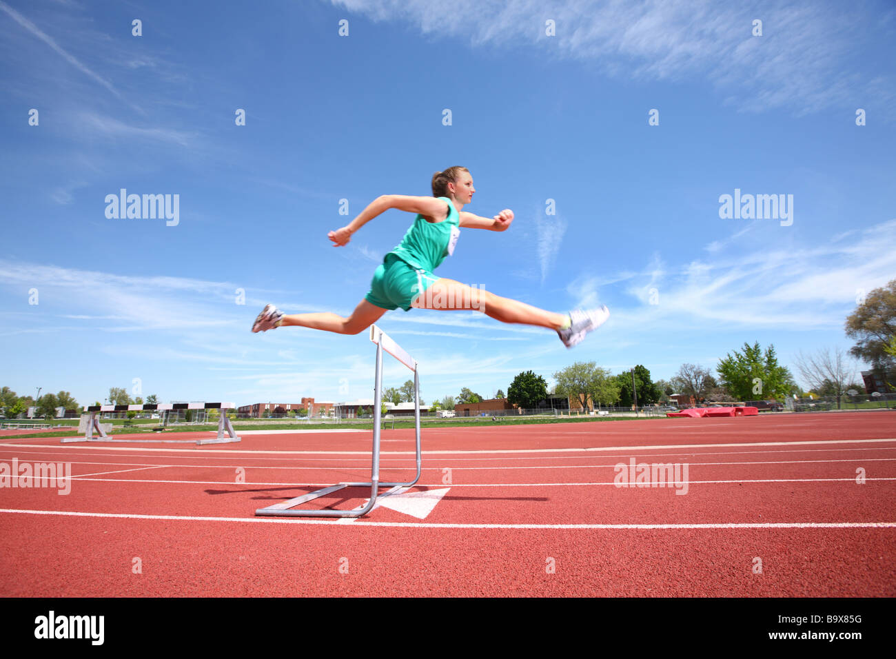 Woman Jumping Over Hurdle Stock Photo Alamy Woman Jumping Over Hurdle Stock Photo Alamy