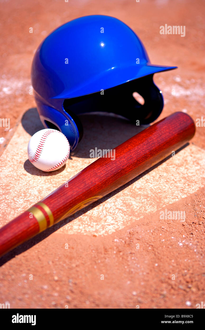 Baseball bat cap and ball on home base Stock Photo Alamy