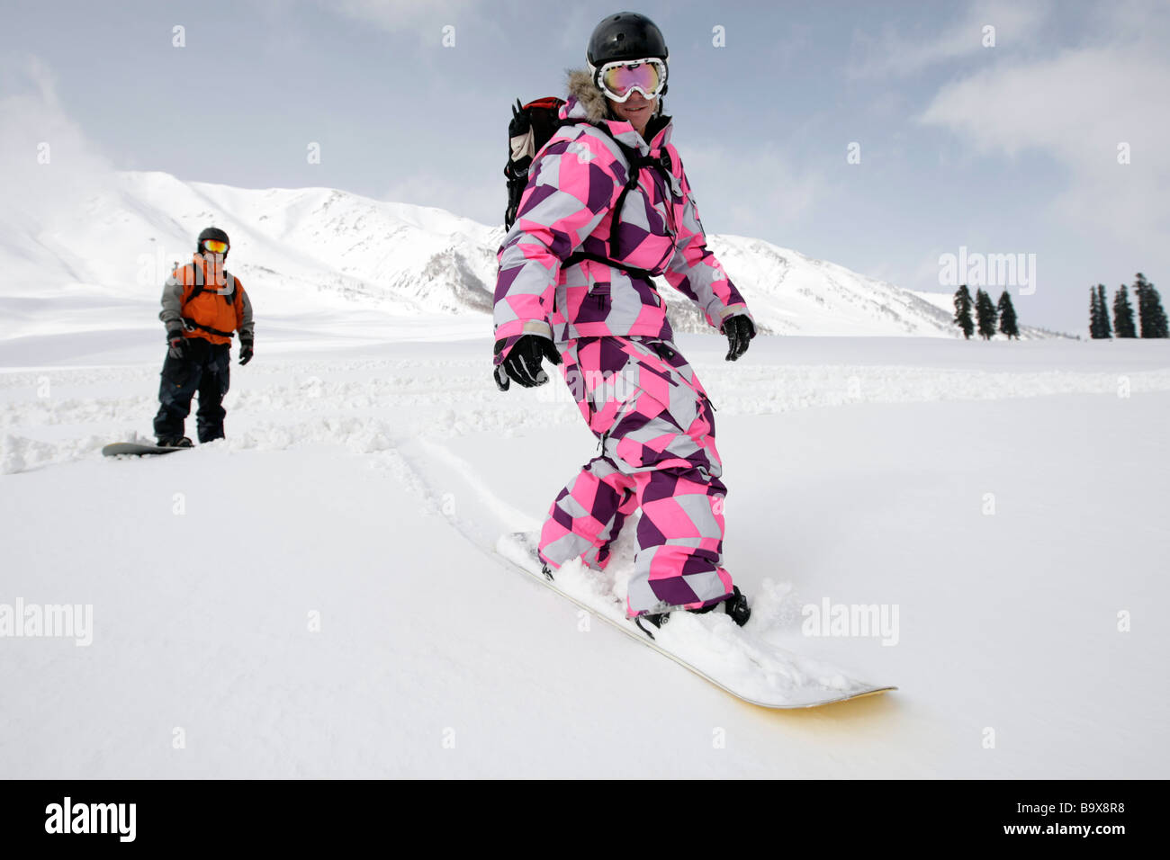 Snowboarders enjoy a run at Gulmarg ski fields Kashmir India where the highest Gondola in the world is near the Pakistan border Stock Photo