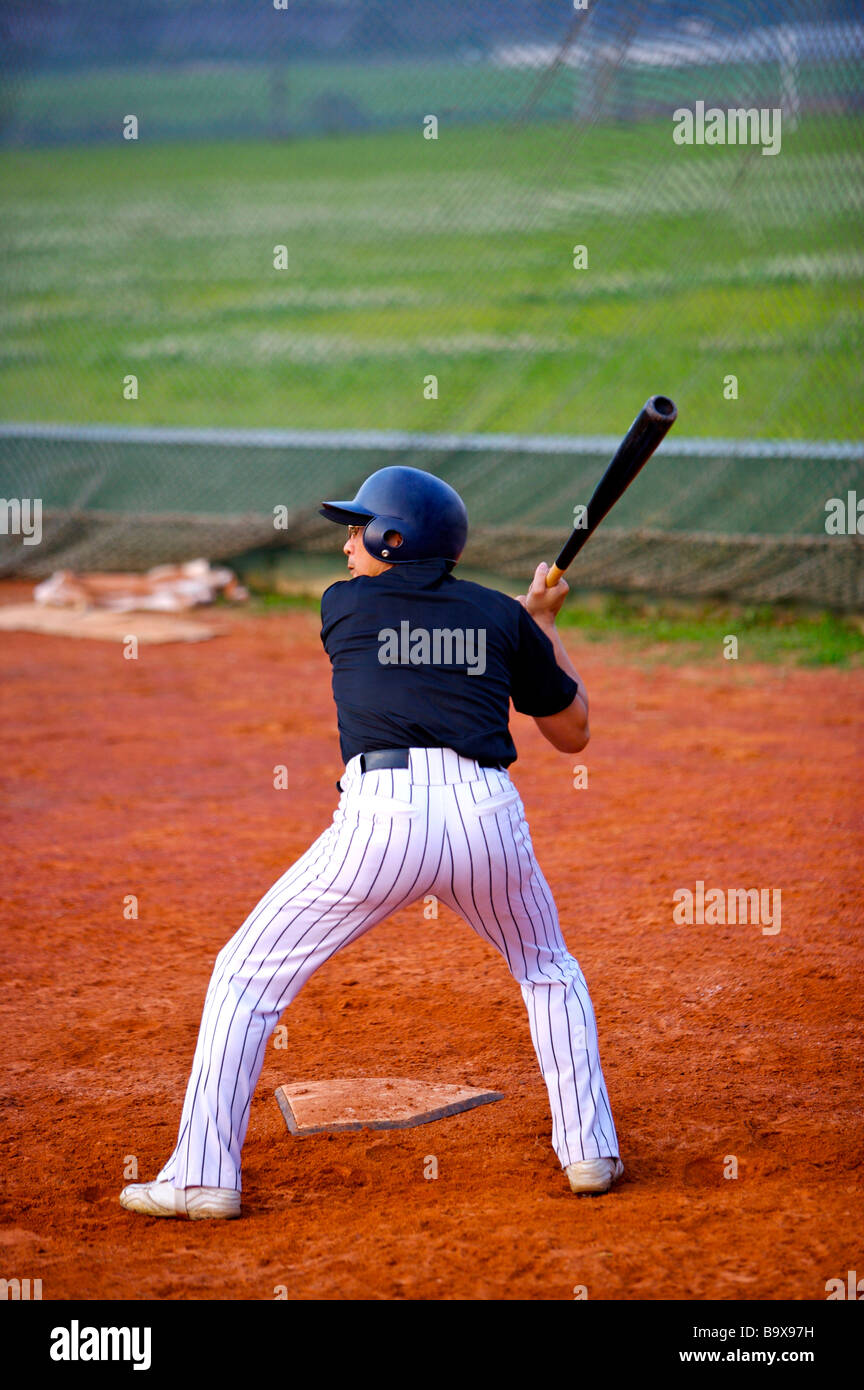 Baseball player swing bat on home plate Stock Photo Alamy