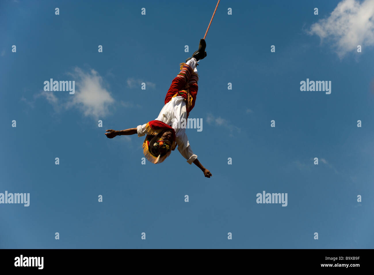 A Mexican Voladore, swiinging upside down during the 