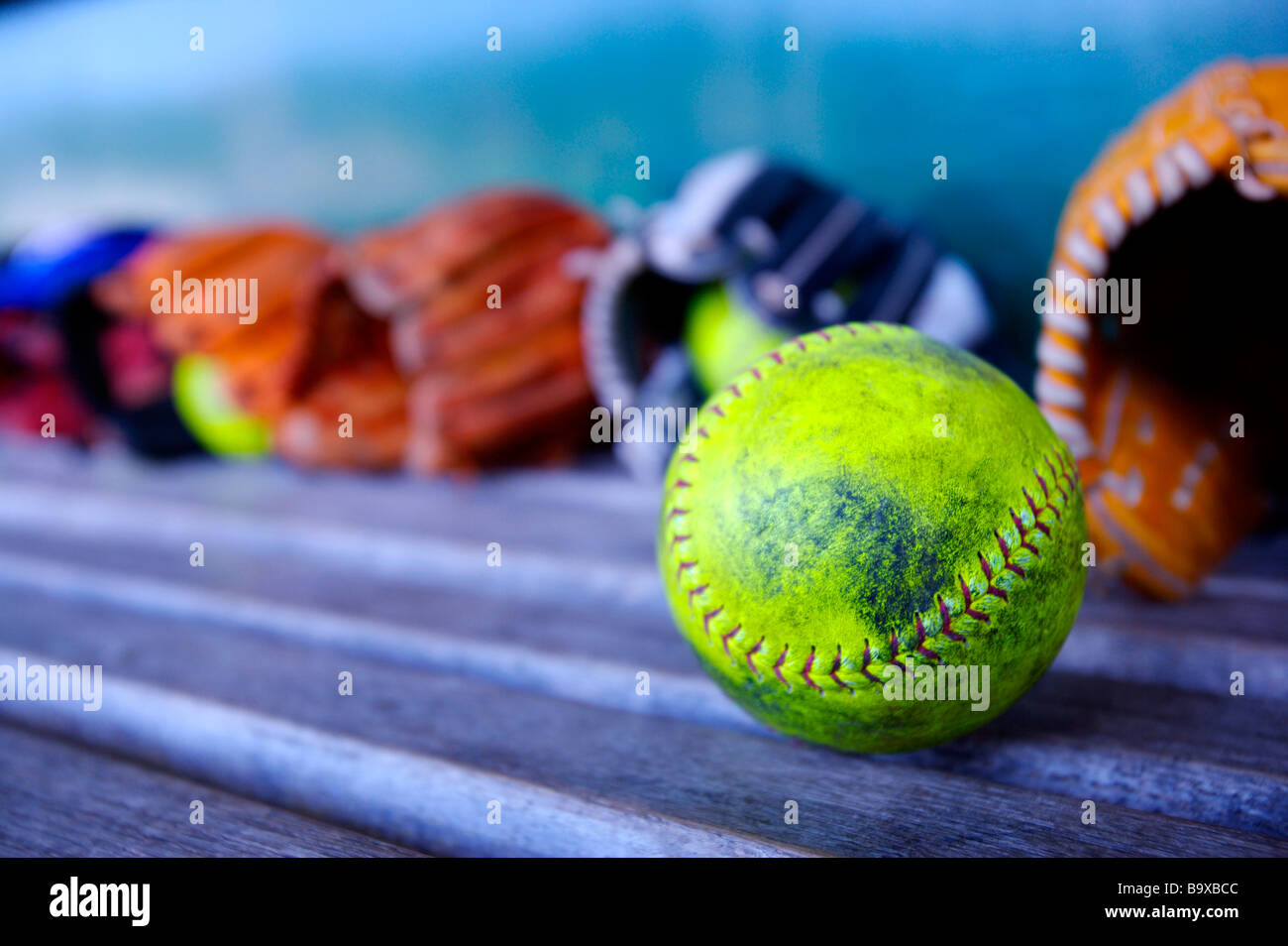 Baseball gloves and ball on bench Stock Photo Alamy