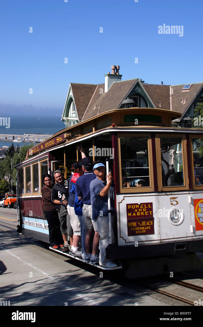 Visitors ride up the Powell Hyde cable car line from Fisherman's wharf