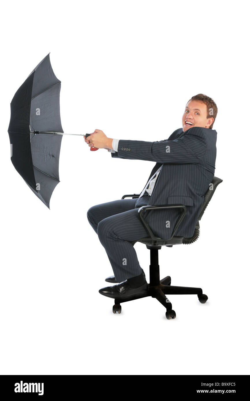 happy businessman catching wind by umbrella Stock Photo
