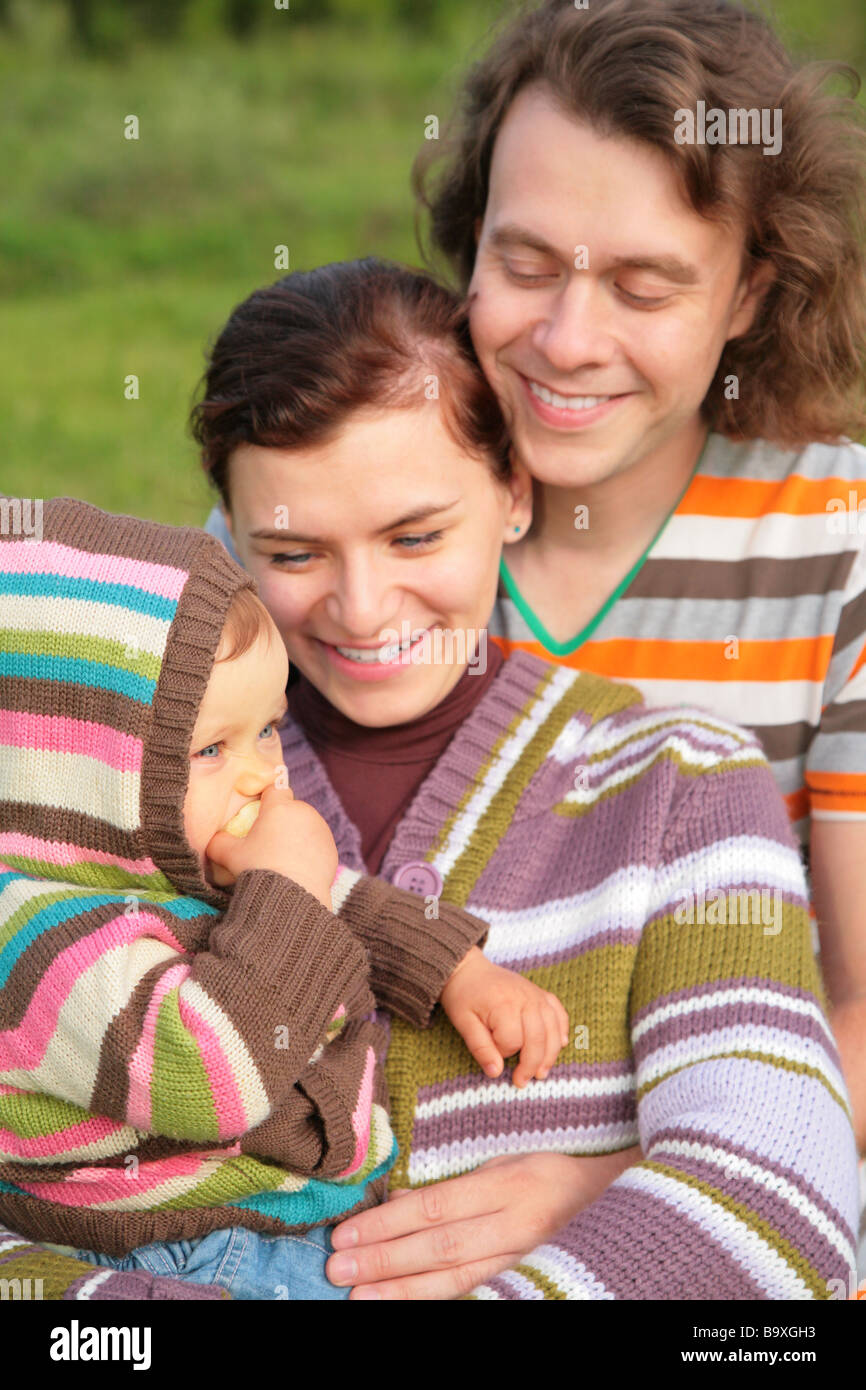 Mother, father and baby on nature Stock Photo - Alamy
